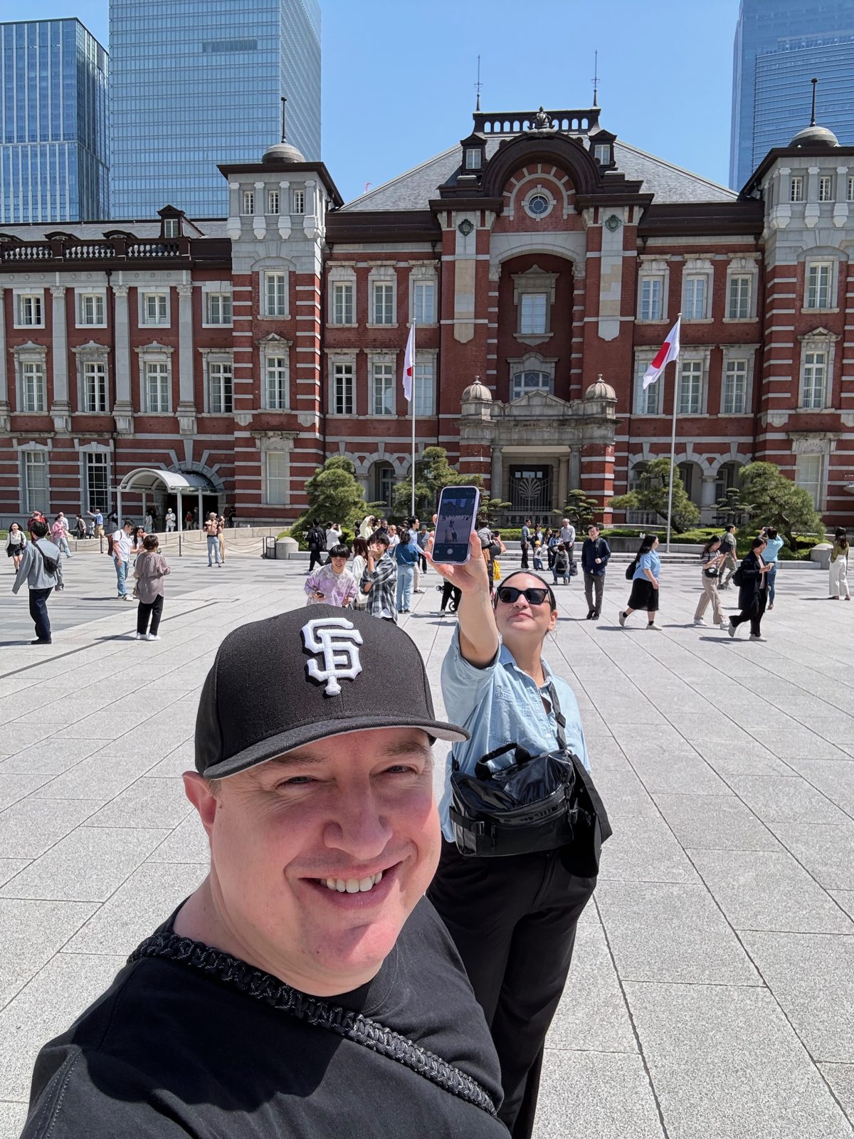 The red-brick Marunouchi facade of Tokyo Station under a blue sky, spring 2024