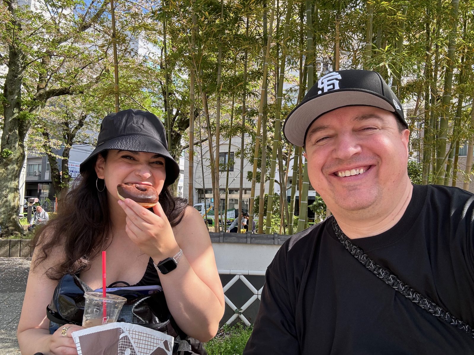 A chocolate doughnut and iced coffee on a sunny spring day in Tokyo, bamboo behind